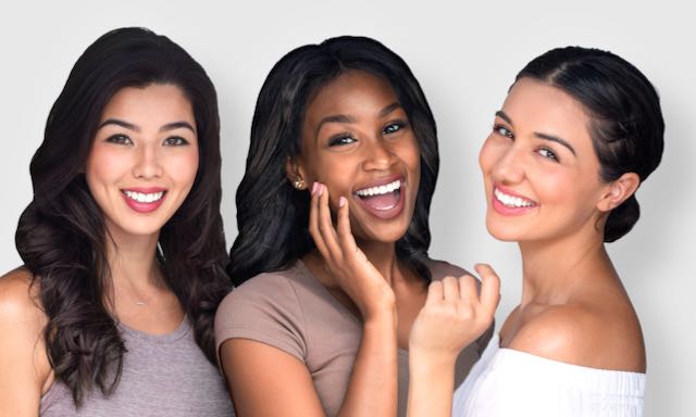 Three young girls, one Asian, one Black and one Caucasian with beautiful makeup smiling. 
