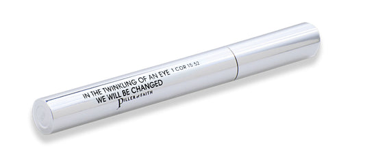 Silver mascara wand with lid and black text featuring scripture: In the twinkling of an eye, we will be changed 1 COR 15:52. Piller of Faith logo. 